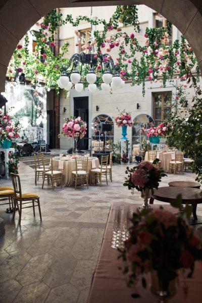 Look from afar at backyard decorated with flowers for wedding di